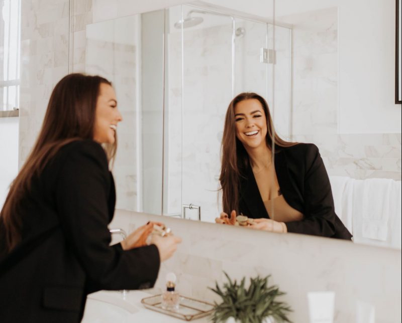 Jac doing skincare routine in bathroom