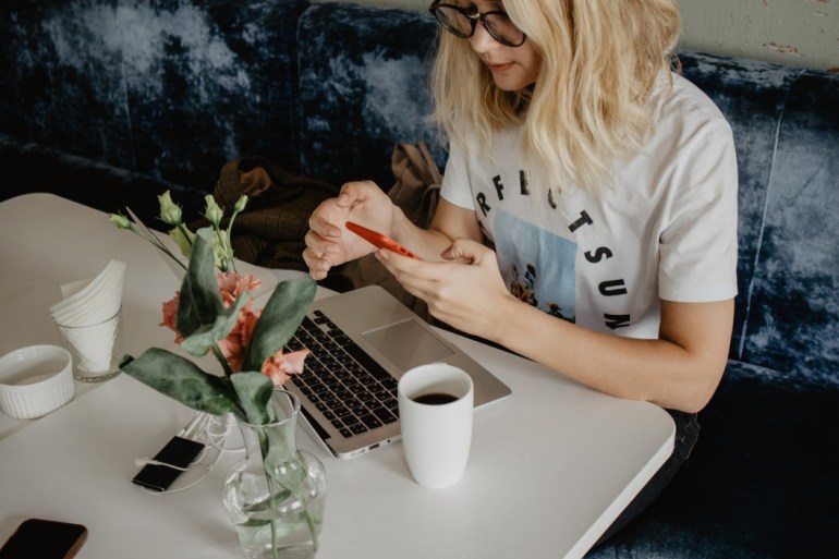 woman doing her weekly planning habits at coffee shop